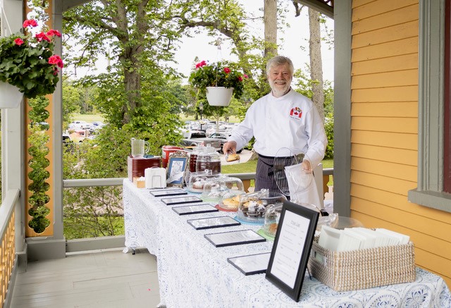 Martin Watson serving Victorian-era cakes and iced tea at the garden of Beaconsfield Historic House