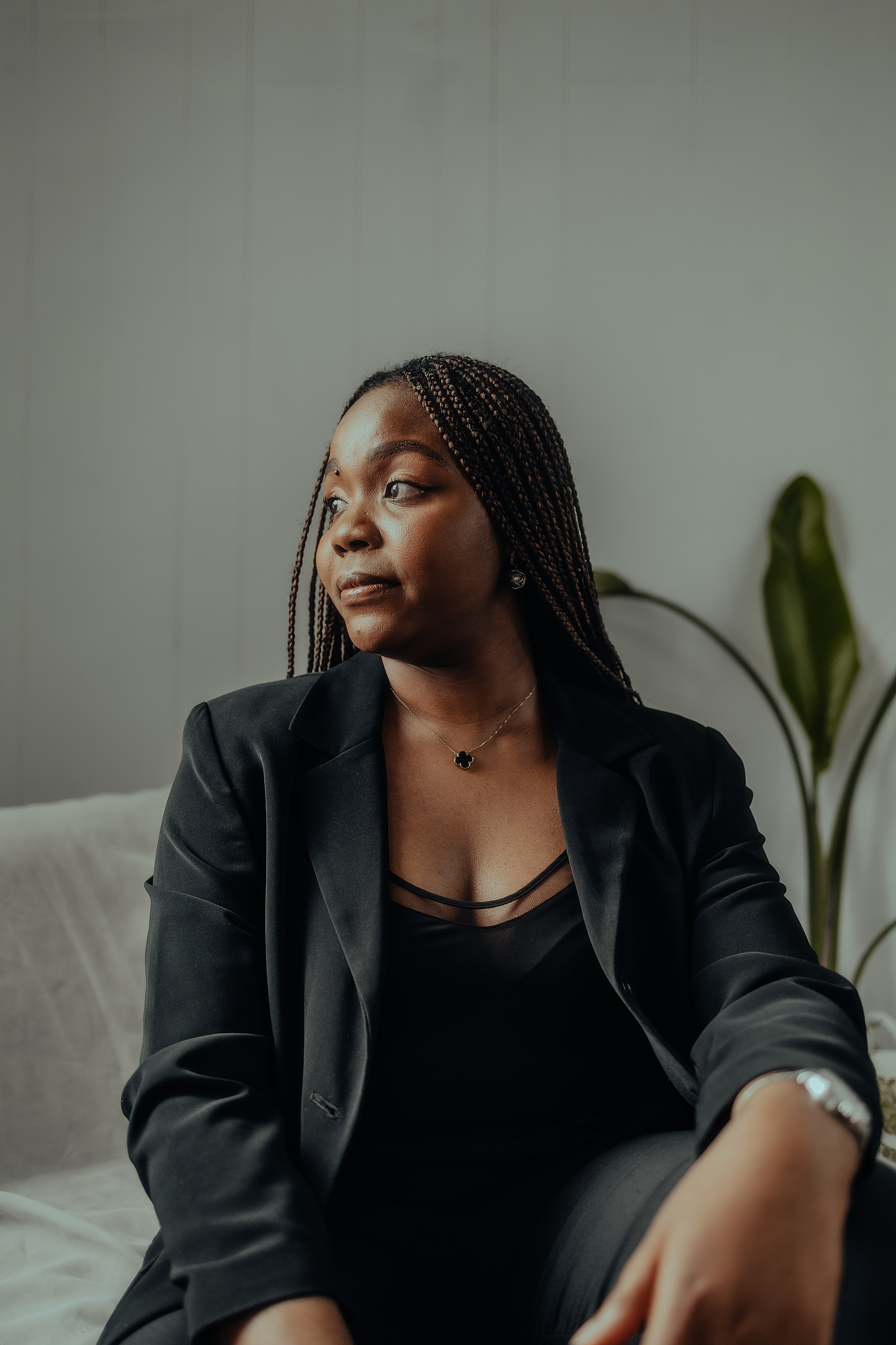 A Black woman in black suit