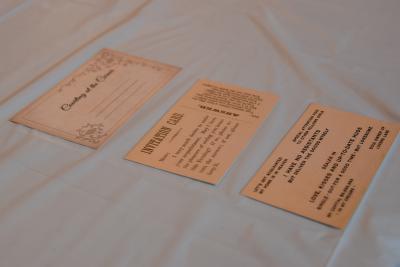 Three small cards sit on a white table cloth.