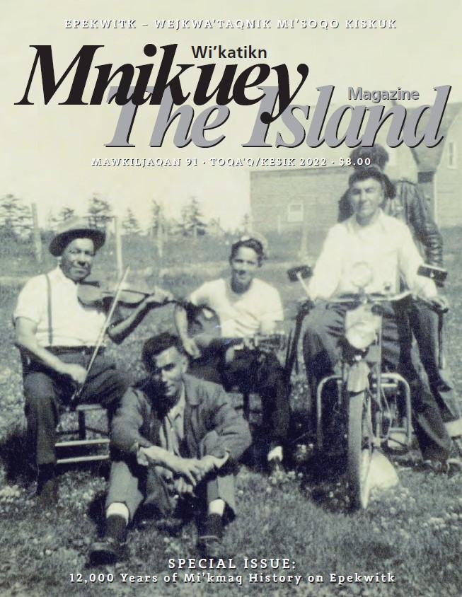 A magazine cover. The title reads "The Island Magazine" in both English and Mi'kmaq. The cover features a black and white image of five men in a grassy field. A man in front is seated on the grass, while behind him two men with musical instruments - a fiddle and a guitar - are seated on chairs. Another man is seated on a motorcycle and a fifth stands behind him, partially obscured.