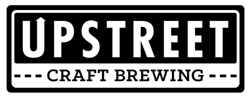 A black and white sign which reads: "Upstreet Craft Brewing".