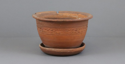 Flower pot made by the PEI Pottery Company with attached saucer.