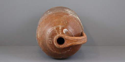Top view of a PEI Pottery Company jug with incised decorative lines and quantity mark.
