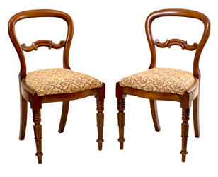 A pair side chairs made by Mark Butcher, identifiable by clear stylistic elements distinct to Butcher such as inverted tulip motifs on turned legs.