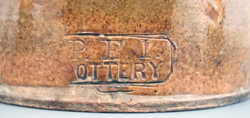 Detailed shot of most common PEI Pottery Company maker's stamp.